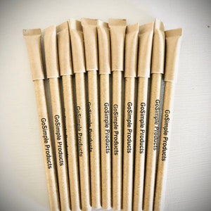 May include: A bundle of ten pens with a natural, light brown paper barrel and a matching paper sleeve. The text "GoSimple Products" is printed vertically on each pen. The pens are arranged in a neat, parallel row.