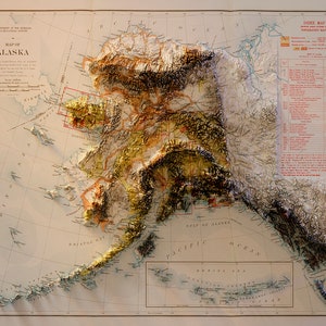 May include: A vintage map of Alaska showing the terrain in a relief style. The map is printed on cream-coloured paper with a grid overlay. The map includes the text "MAP OF ALASKA" and "DEPARTMENT OF THE INTERIOR, U.S. GEOLOGICAL SURVEY".