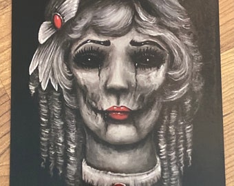 May include: A black and white illustration of a woman with a pale complexion and red lips. She has a white flower in her hair and a red jewel on her neck. The background is black.