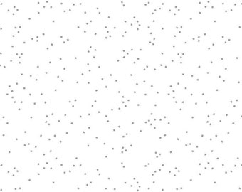 Könnte beinhalten: Weißer Stoff mit einem verstreuten Muster aus kleinen grauen Diamanten. Der Stoff ist mit einem Lineal in Zoll gekennzeichnet.