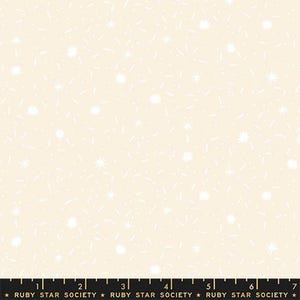 May include: Cream-colored fabric with a repeating pattern of white starbursts, small dots, and dashes. The fabric has a soft, textured appearance, suitable for quilting or other craft projects. The bottom of the image has a ruler with the text "RUBY STAR SOCIETY".