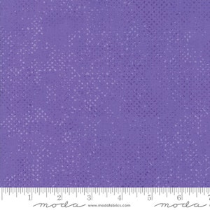 May include: Purple fabric with a white and light purple speckled pattern. The fabric is a quilting cotton and has a soft, smooth texture.