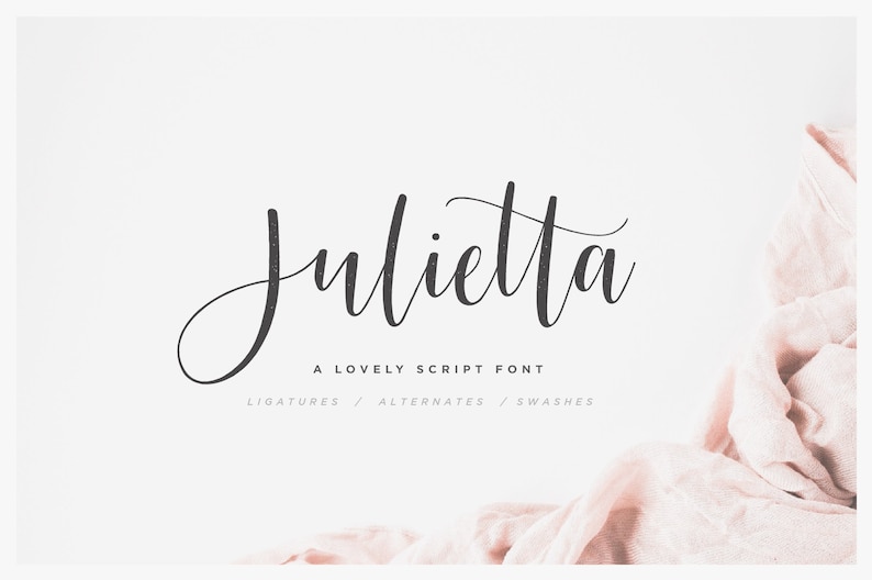 May include: A script font named "Julietta" in black text on a white background. The text reads "A Lovely Script Font" and "Ligatures / Alternates / Swashes". A pink fabric is in the bottom right corner of the image.