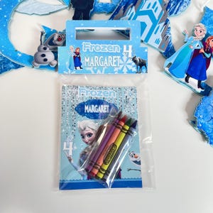 May include: A clear plastic bag containing a Frozen-themed coloring activity set for a 4th birthday. The package features the name MARGARET, images of Elsa, Anna, Olaf, and Sven, and includes four Crayola crayons in purple, orange, yellow, and blue.
