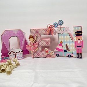 May include: A handmade wooden sign with the text "Welcome" in a playful font. The sign is painted white with a distressed finish, and features a decorative floral design in shades of pink and green. It measures approximately 12 inches wide.