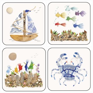 May include: Four square coasters with beach-themed designs. One coaster features a sailboat made of driftwood and blue and white china. Another shows colorful fish above a bed of pebbles. The third depicts birds, and the last a crab.