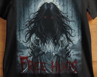 May include: Black t-shirt featuring a spooky graphic. The design depicts a ghostly figure with long black hair, red eyes, and outstretched hands. The words "FREE HUGS" are printed in red across the bottom of the image.