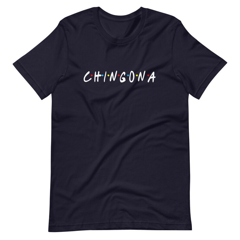 May include: Navy blue t-shirt with the text "CHINGONA" in white letters with colorful dots.
