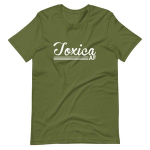 May include: A green short-sleeved t-shirt with the text "Toxica AF" in white cursive lettering.