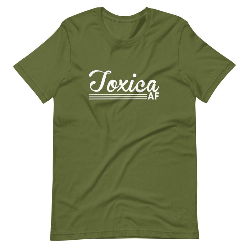 May include: A green short-sleeved t-shirt with the text "Toxica AF" in white cursive lettering.