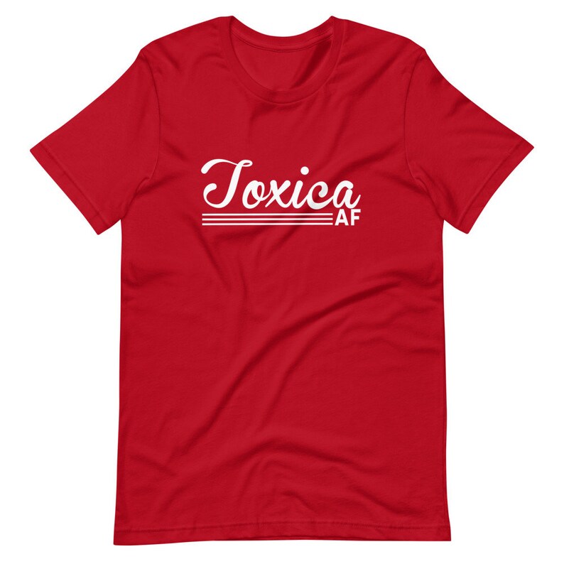 May include: Red short-sleeved t-shirt with white text that reads "Toxica AF" in a retro font.