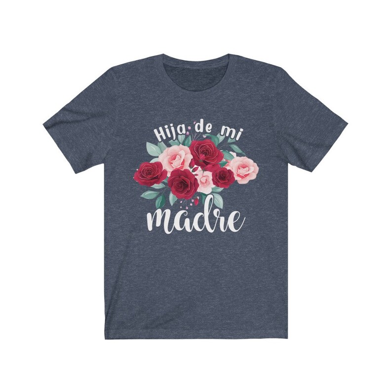May include: A navy blue t-shirt with a floral design and the text "Hija de mi madre" in white.