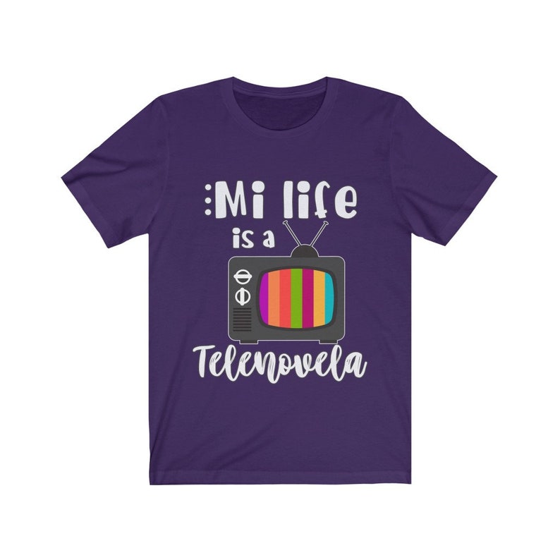 May include: Purple t-shirt with a white graphic of a vintage television with the text "Mi life is a Telenovela".