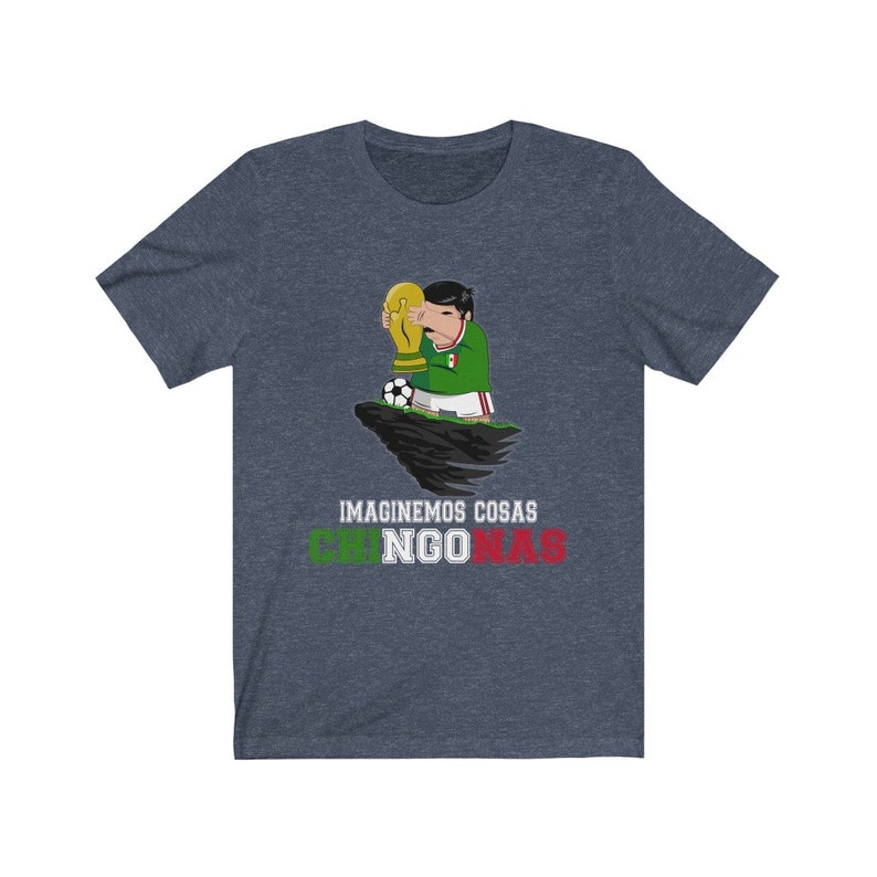 May include: Navy blue t-shirt featuring a cartoon figure in a green and white soccer uniform holding a gold trophy. A soccer ball sits nearby. The text "IMAGINEMOS COSAS CHINGONAS" is printed below the image in green and red.