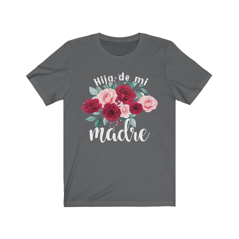 May include: A dark gray t-shirt with a floral design and the text "Hija de mi madre" in white.
