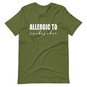 May include: A green t-shirt with the text "ALLERGIC TO pendejadas" in white.