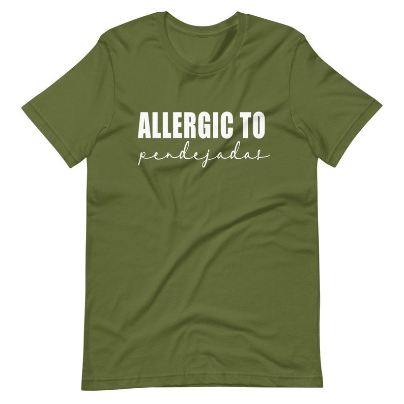 May include: A green t-shirt with the text "ALLERGIC TO pendejadas" in white.