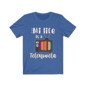 May include: A royal blue t-shirt with white text that reads "Mi life is a Tele novela" and a cartoon image of a vintage television with a rainbow screen.