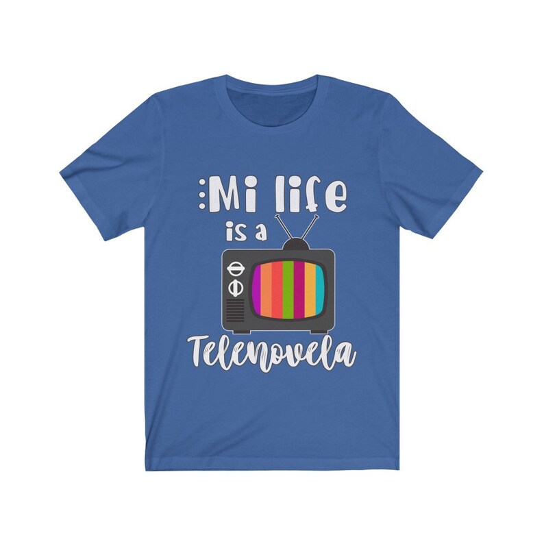 May include: A royal blue t-shirt with white text that reads "Mi life is a Tele novela" and a cartoon image of a vintage television with a rainbow screen.