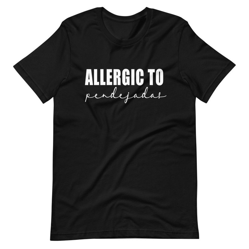 May include: Black t-shirt with white text that reads "ALLERGIC TO pendejadas".