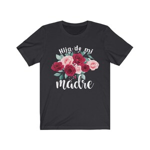 May include: Black t-shirt with a floral design and the text "Hija de mi madre" in white.