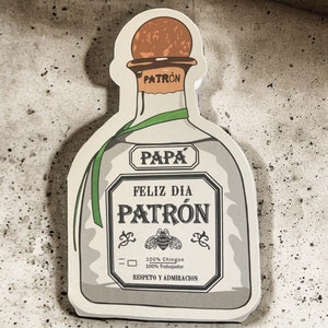 May include: A white and green illustration of a Patron tequila bottle with the text "Pap&aacute; Feliz D&iacute;a Patr&oacute;n 100% Ching&oacute;n 100% Trabajador Respeto y Admiraci&oacute;n"