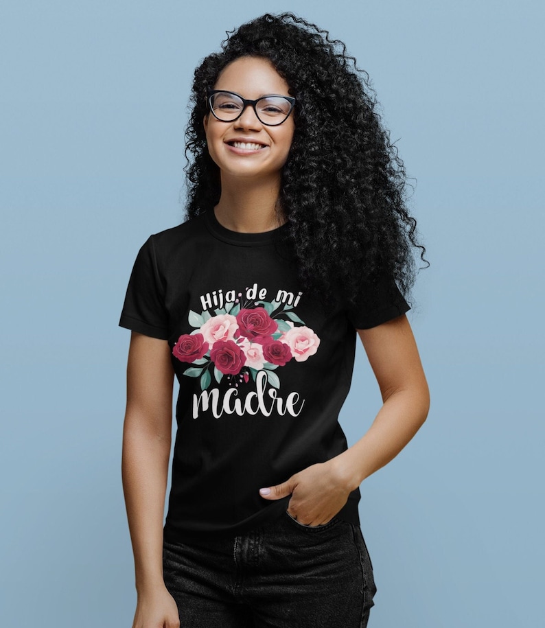 May include: Black t-shirt with a floral design and the text "Hija de mi madre" in white.