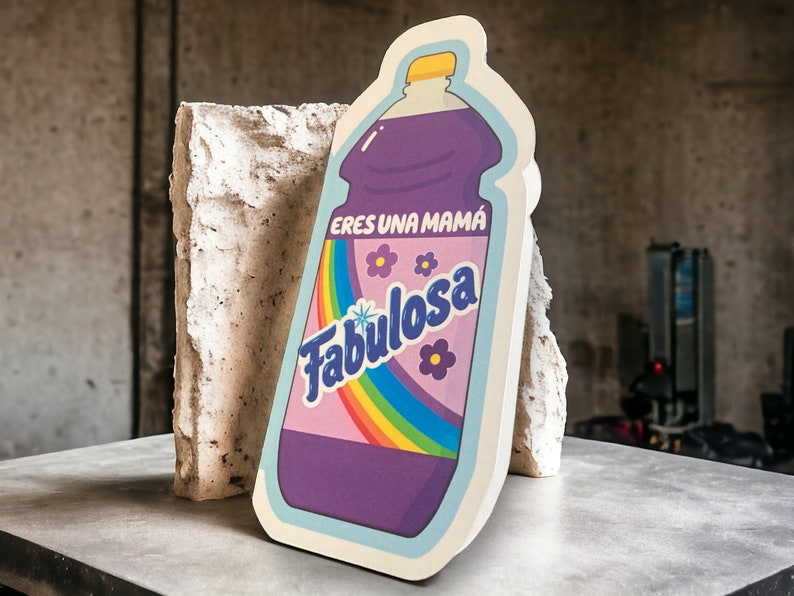 May include: A purple bottle with a rainbow and the text "Eres una mama Fabulosa" on the label.