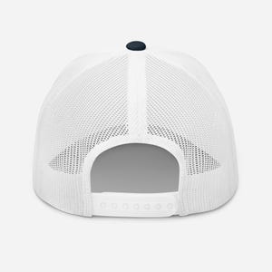 May include: White mesh trucker hat with a navy blue crown and a white snap closure.