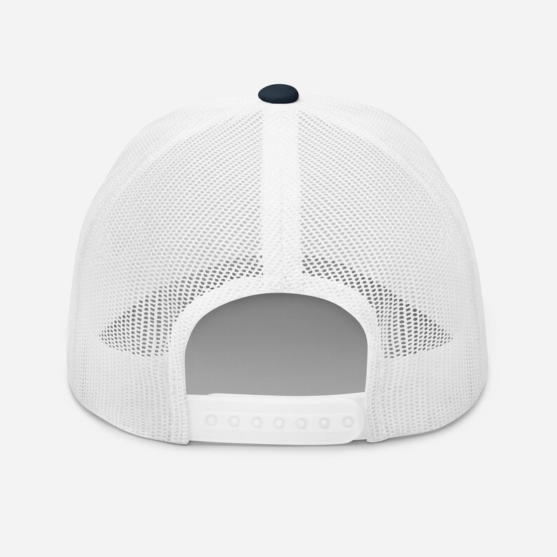 May include: White mesh trucker hat with a navy blue crown and a white snap closure.