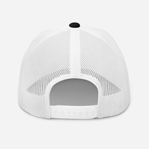 May include: White mesh trucker hat with a black crown. The hat has a snap closure and a white mesh back.
