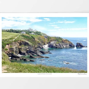 May include: A scenic view of a rocky coastline with a small building on a cliff overlooking the ocean. The water is a bright blue and the sky is a clear blue with white clouds. The photo was taken from a grassy hilltop.