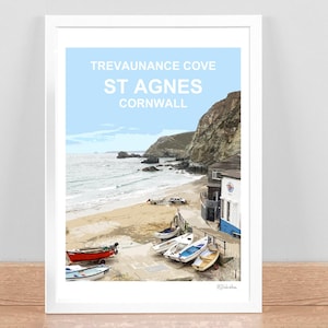 May include: A framed art print of Trevaunance Cove, St Agnes, Cornwall. The image features a beach scene with boats, buildings, and a cliffside. The sky is light blue, and the text "Trevaunance Cove, St Agnes, Cornwall" is at the top.