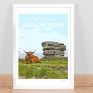 Puede incluir: Una impresión enmarcada de una vaca de las tierras altas acostada en un campo con una gran formación rocosa en el fondo. La impresión tiene el texto "Eagle Stone Baslow Edge Derbyshire" en la parte superior.