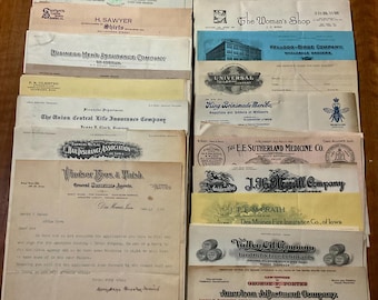 May include: A collection of vintage business documents and letterheads, featuring various company names and logos. The papers are arranged in a stack, showcasing historical ephemera from different businesses.