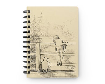 May include: A black and white illustration of Winnie the Pooh and Piglet standing on a wooden bridge, looking over a fence at a body of water. The illustration is on a beige background.