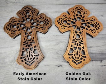 May include: Two wooden crosses with intricate cutouts, one stained in an Early American color and the other in Golden Oak.