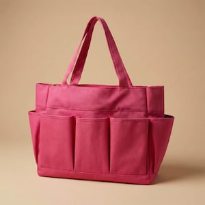 May include: A magenta tote bag with multiple exterior pockets. The bag has two handles for carrying and is made of a sturdy fabric. The design includes several pockets on the outside for easy access to items.