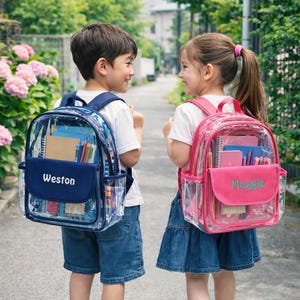 May include: Two children wearing clear backpacks with school supplies. One backpack is navy blue with "Weston" embroidered on the front pocket. The other is pink with "Maggie" embroidered on the front pocket. Both backpacks have side pockets and are filled with notebooks and pencils.