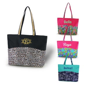May include: Four tote bags with different patterns and personalized names. The bags are black, pink, turquoise, and pink with a floral pattern. The names on the bags are Bella, Raya, Samuel, and R.B.D.