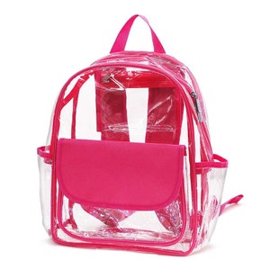 May include: A clear backpack with a bright pink trim, handle, and front pocket. The backpack has a zippered main compartment, two side pockets, and adjustable shoulder straps. The clear design allows for easy visibility of the contents.