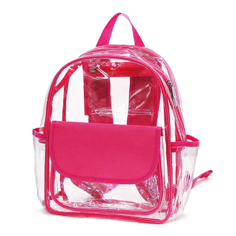 May include: A clear backpack with a bright pink trim, handle, and front pocket. The backpack has a zippered main compartment, two side pockets, and adjustable shoulder straps. The clear design allows for easy visibility of the contents.