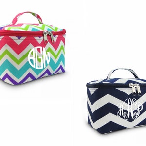 May include: Two zippered cosmetic bags with chevron patterns. One bag is pink, green, blue, and purple. The other bag is navy blue and white. Both bags have a white monogram.