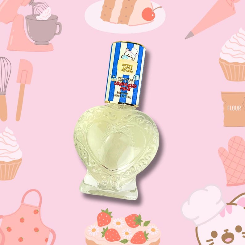 May include: A heart-shaped glass bottle of "Kitty's Kitchen Condensed Milk" perfume. The bottle is clear and has a gold-colored cap with a blue and white striped label featuring a cartoon cat chef. The label also says "Kitty's Kitchen Condensed Milk" and "Perfume Net 10 ml."