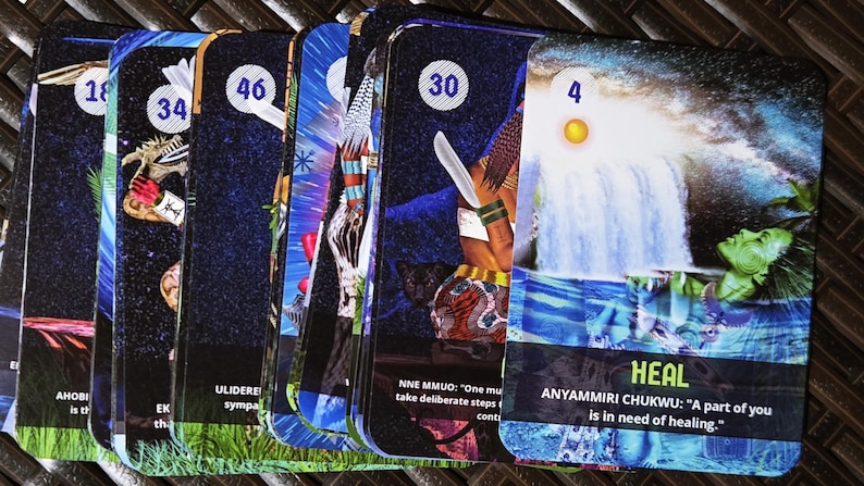 May include: A collection of oracle cards with colorful illustrations and text. Each card features a unique image, number, and text, with themes of healing and spirituality. The cards have a dark blue background with various images and text.