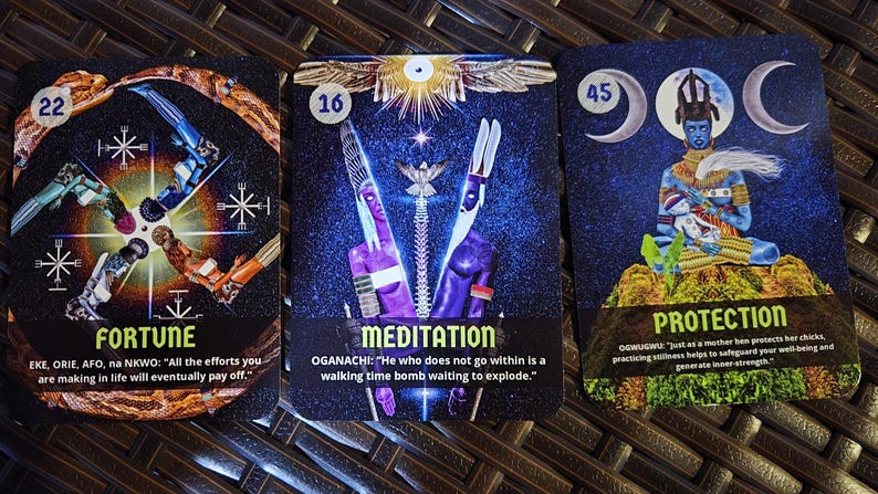 May include: Three tarot cards with vibrant illustrations and text. The cards feature the words "FORTUNE", "MEDITATION", and "PROTECTION". Each card has a unique design with figures and symbols against a dark, starry background. The cards are displayed on a textured surface.