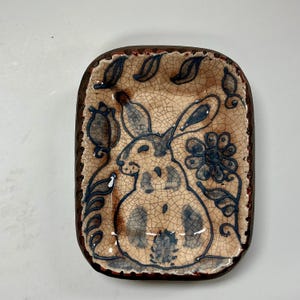 May include: A white ceramic mug with a black handle and the text "But First, Coffee" in a handwritten style. The mug is likely 11-15 ounces, perfect for a morning beverage.