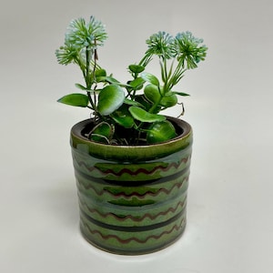 May include: A white ceramic mug with a black handle and the text "But First, Coffee" in a handwritten style. The mug is likely 11-15 ounces, perfect for a morning beverage.