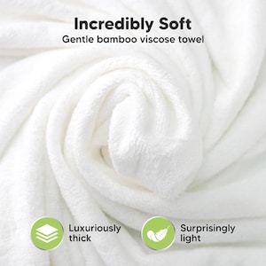 May include: A close-up of a white, folded towel. The towel is made of bamboo viscose and is described as incredibly soft, luxuriously thick, and surprisingly light. Text on the image reads "Incredibly Soft" and "Gentle bamboo viscose towel."