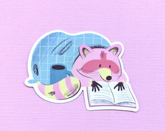 Cute Cozy Raccoon with Book Waterproof Stickers, Book Lovers, Raccoon Lover Gift, Glossy Vinyl Sticker, Raccoon with blanket